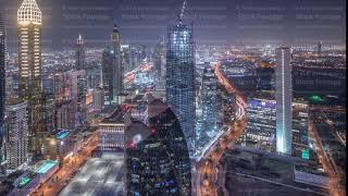 Skyline of the buildings of Sheikh Zayed Road and DIFC aerial night timelapse in Dubai, UAE.
