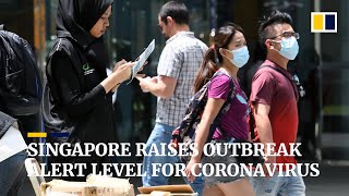 Singapore raises outbreak alert level after signs of community spread of coronavirus