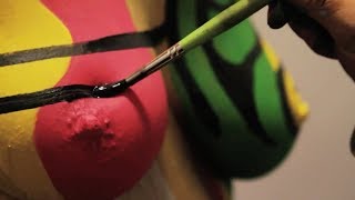 Watch up close body painting of a nude model, with body art by Andy Golub
