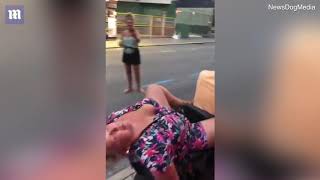Video: Drunk woman carried on the back of a mobility scooter through city