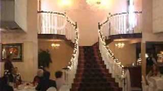Bichon Frise dog making grand entrance at wedding reception.