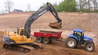 Volvo EC210B Excavator Loading John Deere And New Holland Tractors