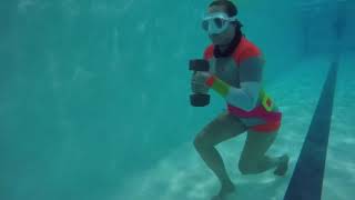 Girl walks underwater with weight