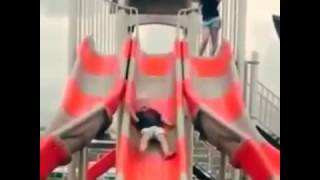 kid sliding down slide hits head