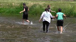Wetlook girl -   In river with clothes and shoes