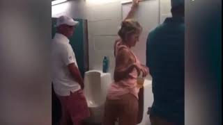 Drunk woman seen peeing in urinal at Florida football game!! MUST WATCH !!
