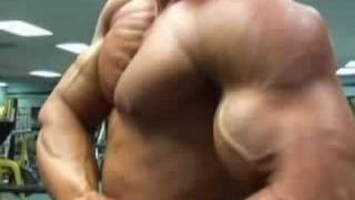 Bren Baldwin posing biceps and pecs