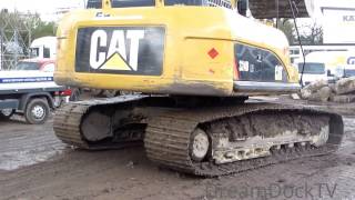 CATERPILLAR 324D EXCAVATOR LOADING DUMP TRUCKS WITH DIRT