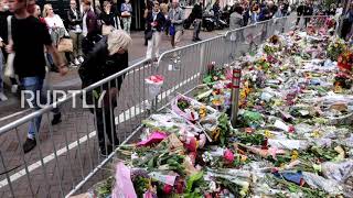 Mourners leave flowers at spot where crime reporter de Vries was shot after he dies in hospital