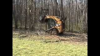 Forestry mulcher on a CAT skid steer clearing our property