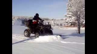 Plowing snow using a Polaris 700 ATV with a Glacier plow
