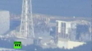 Video of helicopters water-bombing nuclear reactor, close-up shots of Fukushima
