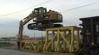 Cat 319D LN climbing onto rail car