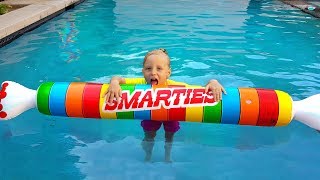 Children Pretend Play with Giant Inflatable Toys & swimming in the pool
