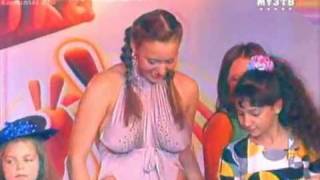 Busty russian singer  in a slutty dress performs  on a  tv show for kids