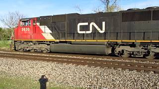 CN SD75I and C40-8W with welded rail train stopped on tracks.