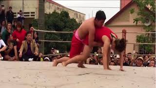 A wrestling match between a female and a young man in Hai Phong, Vietnam is very attractive. (Next)