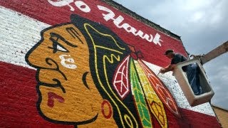 Giant Blackhawks mural painted on brick wall