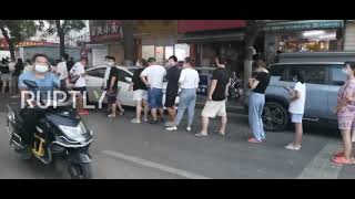 China: Zhengzhou residents queue for COVID tests after lockdown expanded