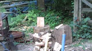 splitting firewood the old fashioned way, heavy Maul and muscles..
