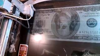 Гравировка доллара на камне.  Engraved on the stone dollar.