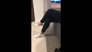Beautiful Asian girl in sneakers and socks shows her feet foot fetish