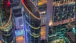 Skyline of the buildings of Sheikh Zayed Road and DIFC aerial night timelapse in Dubai, UAE.