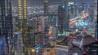 Skyline of the buildings of Sheikh Zayed Road and DIFC aerial night timelapse in Dubai, UAE.