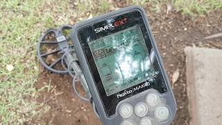 Nokta Makro Simplex metal detector and rusty bottle caps