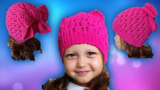 Детская ажурная шапка спицами для девочки с бантом
