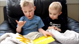 Three Year Old Reading to Little Brother Using Sign Language