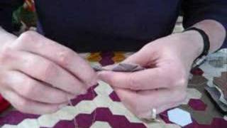 2) demonstration hand sewing patchwork hexagons together