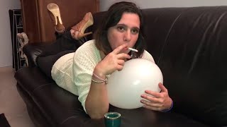 Woman smokes with a balloon