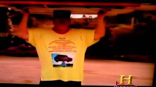 Man lifting a car and holding it on his head