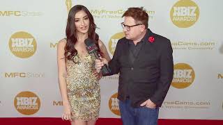 Emily Willis in an gold sequin dress on the Xbiz Awards red carpet in Los Angeles, CA