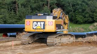 Caterpillar CAT 345D L digging a trench for a gas pipeline