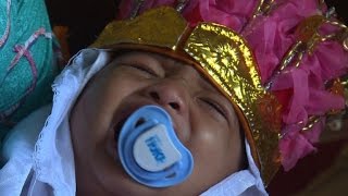 In golden crown, Indonesian girl howls through circumcision