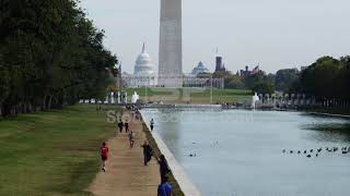 People On Footpath Along Reflecting Pool Washington Monument And Capitol In Background