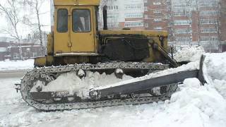 Old soviet dozer on T-170B tractor pushin" snow off the road