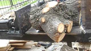 logsplitter splits 12" oak with 5 h.p. engine log has 9 knots in it